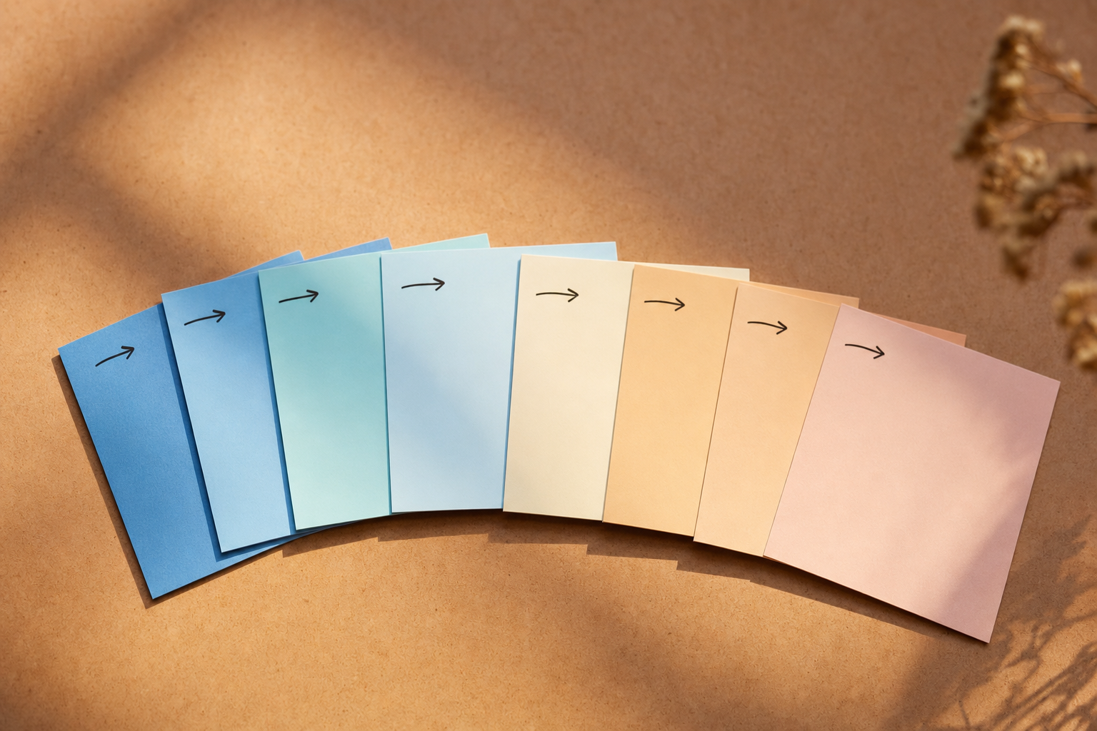 A stack of printed square photo cards fanned out in sequence on a colored surface, suggesting swipeable carousel slides.